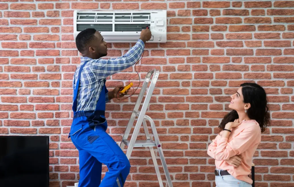 AC tune-up technician inspecting outdoor condenser unit on a sunny day in a residential Utah neighborhood